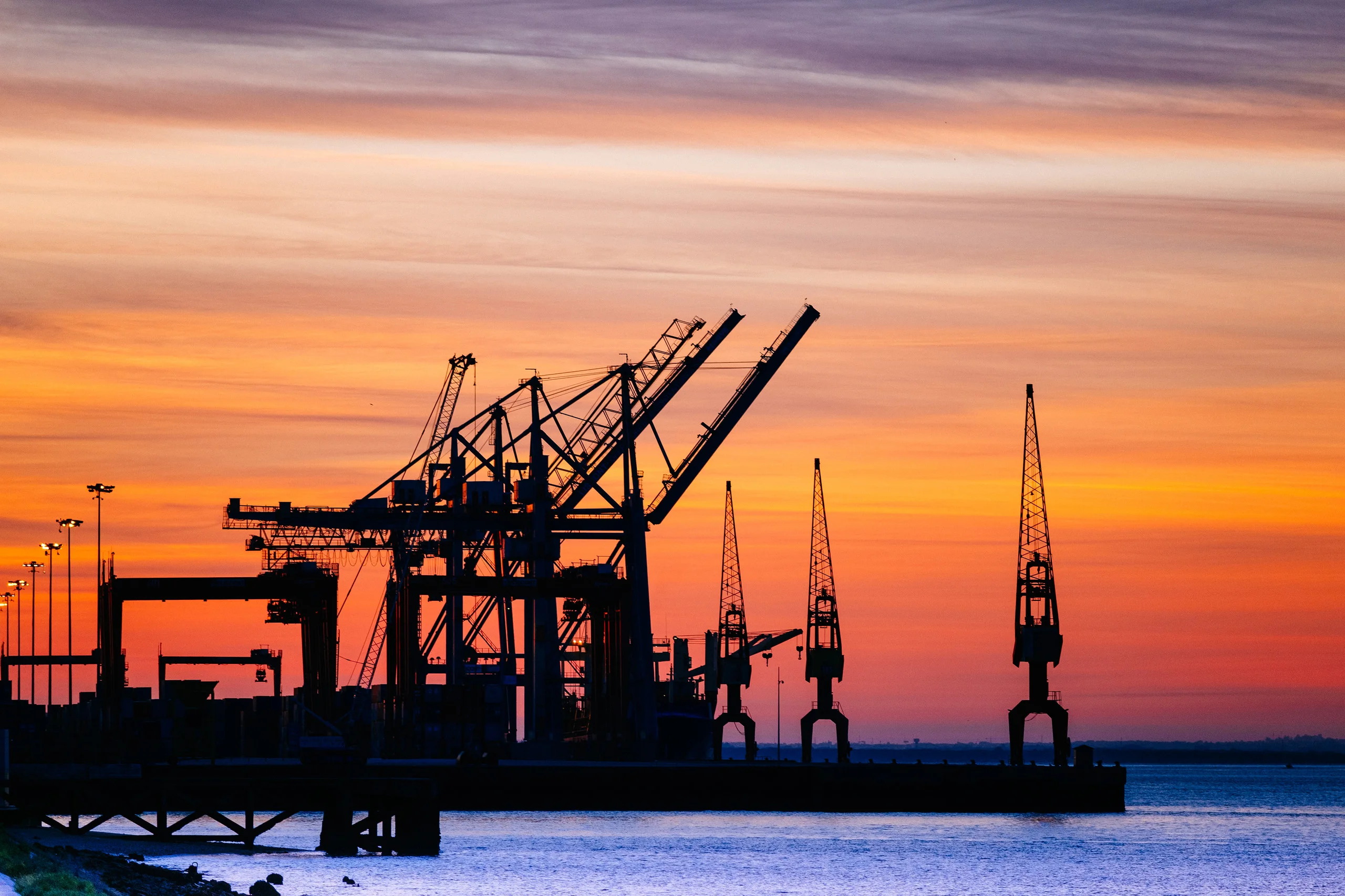 beautiful-silhouette-port-machinery-sunset 1 - Incture Technologies port logistics sunset